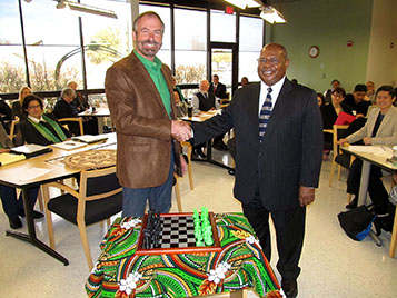 Provost Warren Burgren receives a digitally fabricated chess set from Dean Herman Totten and the COI faculty.